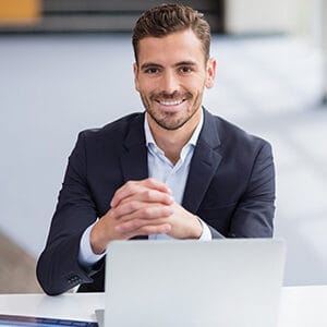 happy businessman sitting with laptop