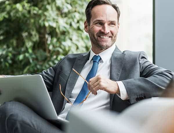 smiling businessman sitting looking at documents